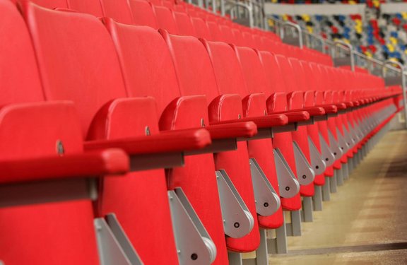 Red seats in a row at MERKUR SPIEL-ARENA.